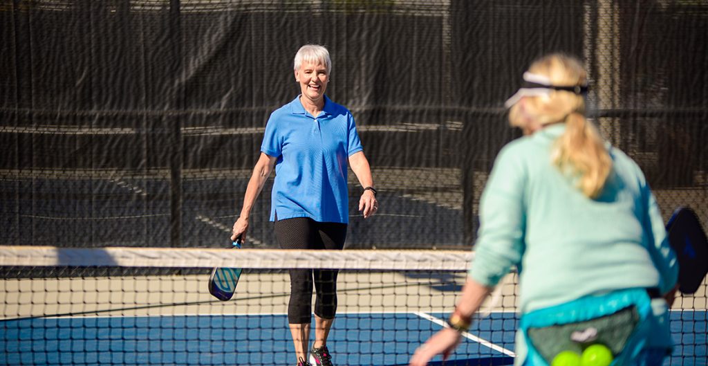 Women playing tennis in an active adult community in Salt Lake City, Utah. 